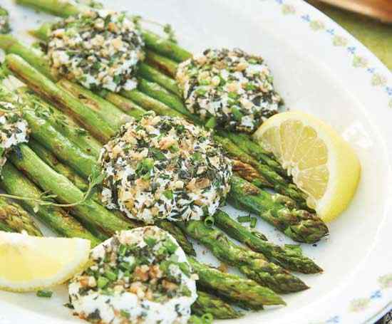 Lemon roasted asparagus is paired with baked goat cheese to make a delectable dish.